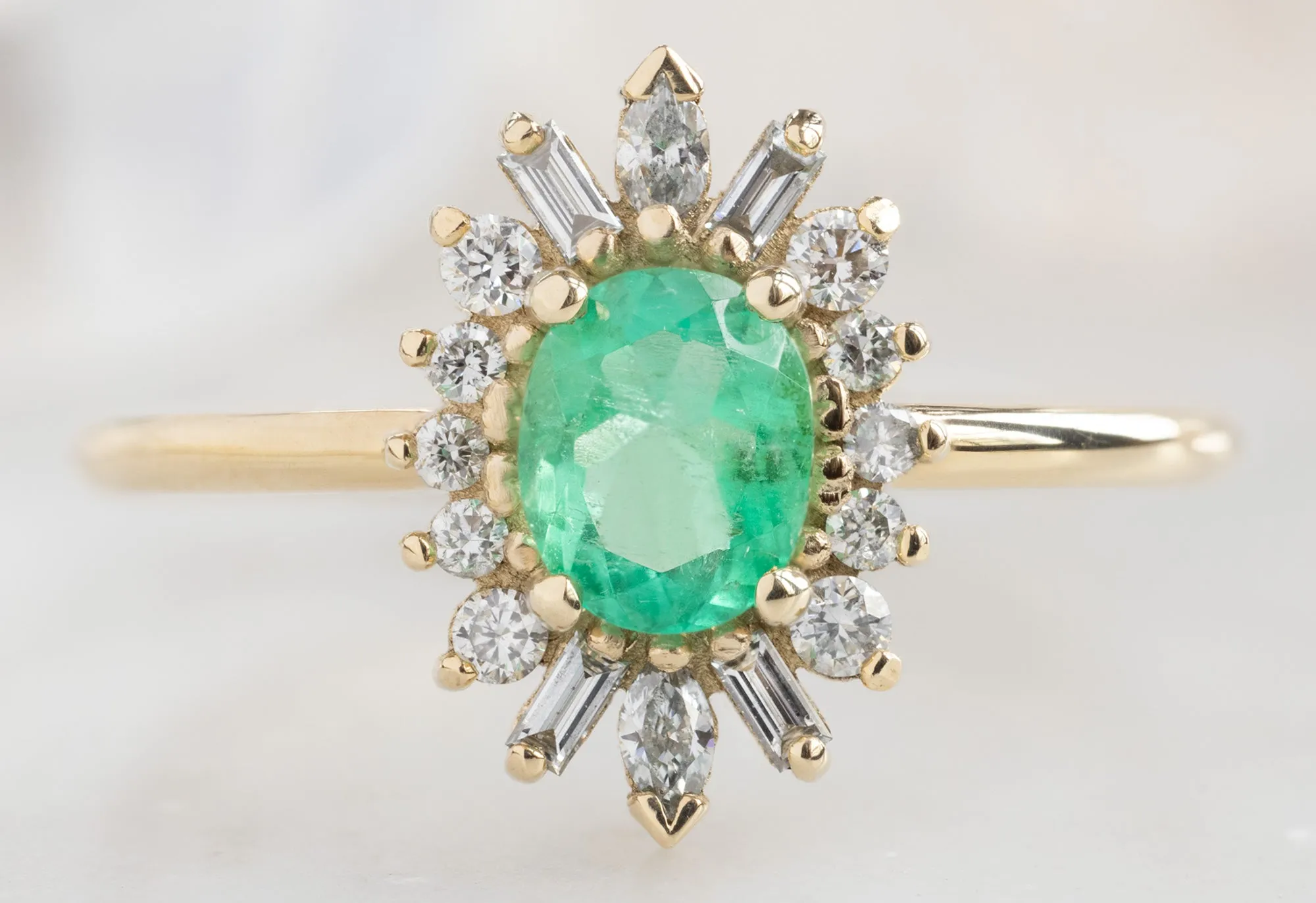 The Camellia Ring with an Oval-Cut Emerald