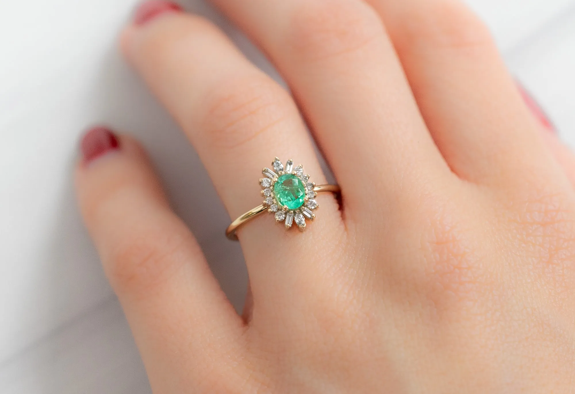 The Camellia Ring with an Oval-Cut Emerald